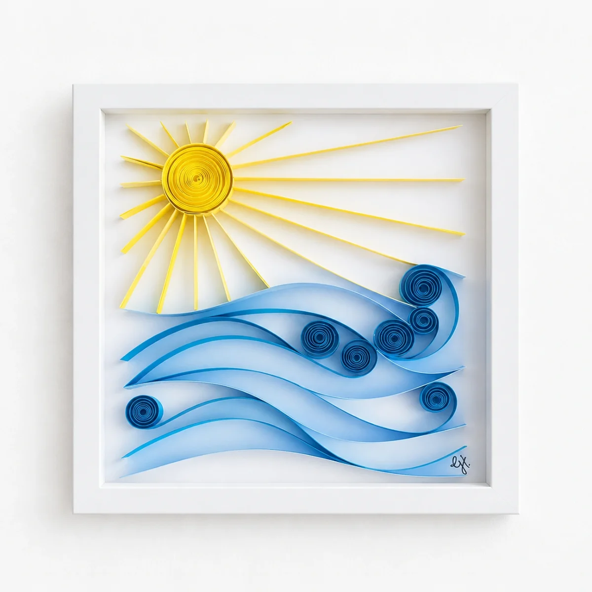 Sun and Sea quilled sun over blue waves in a white shadowbox frame
